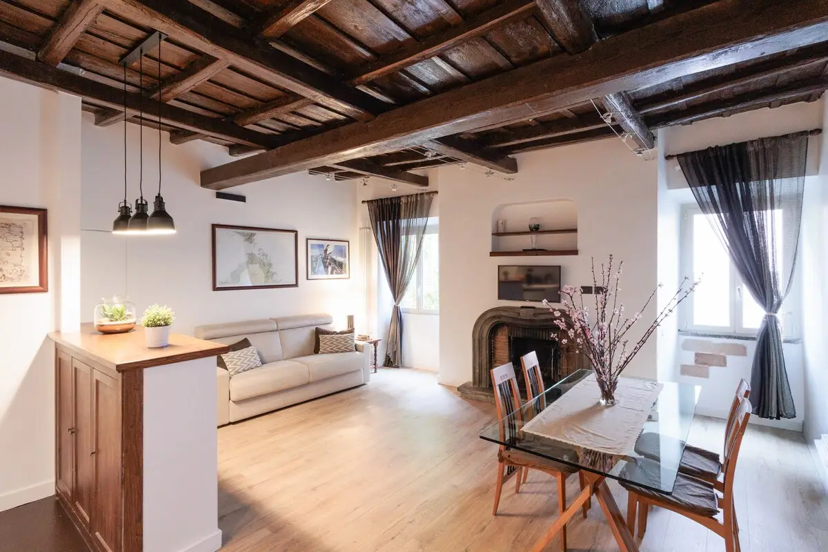 The living room from the entrance, under the beamed ceiling.