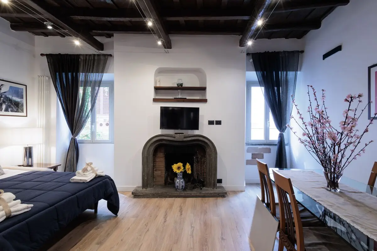 The living room with the sofa bed opened out, between the fireplace and the dining table.