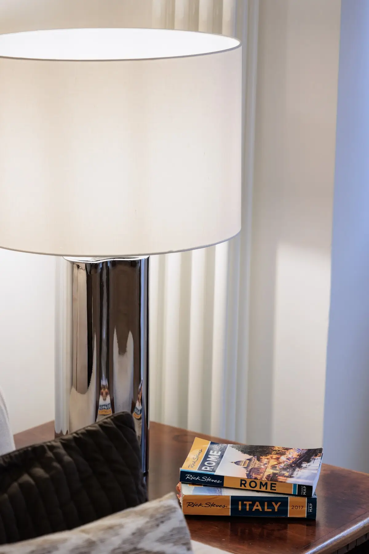 Rome guidebooks on the side table, beside a lamp.